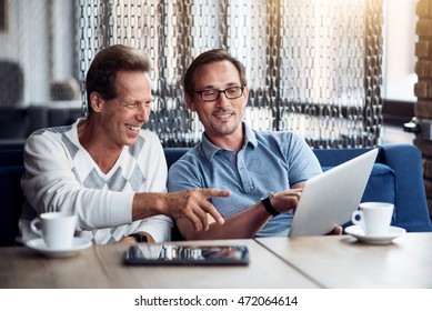 Two Men Holding Computer