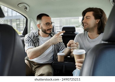 Two men, holding hands and enjoying coffee, converse in the backseat of a car. - Powered by Shutterstock