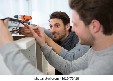 Two Men Installing New Kitchen Hob