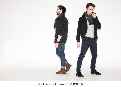 two men in jackets posing in the studio. fashionable young attractive guys