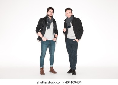 two men in jackets posing in the studio. fashionable young attractive guys