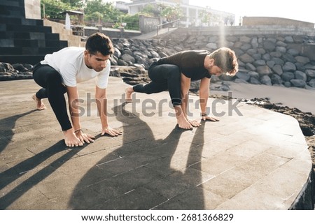 Two men in lizard pose prepare mind and body for flow, showing how physical grounding and breath awareness support cognitive function and mental performance in screen-focused lives.