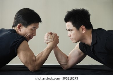 Two men locked in arm wrestling
