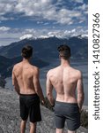 Two men looking at a beautiful view from viewpoint. 