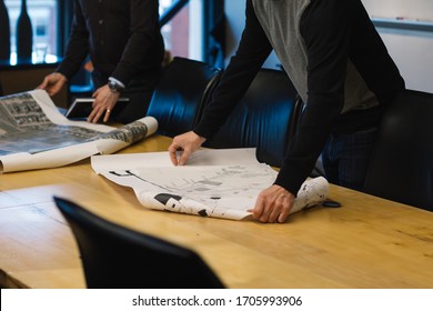 Two Men Looking At City Planning Maps On Table - Urban Community Development