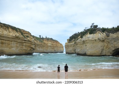 two men looking at the ocean