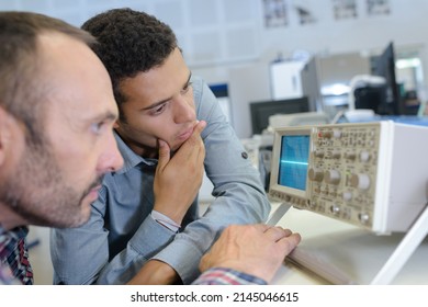 two men looking at radio frequency screen - Shutterstock ID 2145046615