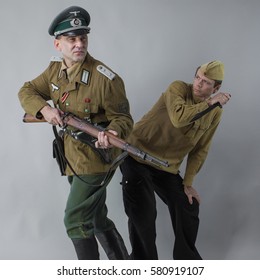 Two Men In Military Uniform Period Of 1930-1940 Years.
Captain Of The Wehrmacht And The Red Army Soldiers Of The Soviet Union