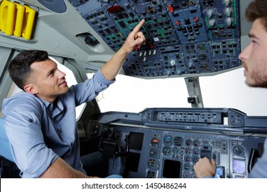 Two Men In Modern Flight Simulator For Pilot Training