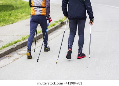 Two Men Nordic Walking Race On City Street