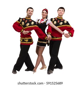 Two Men And One Woman Wearing A Folk Russian Costume Posing Against Isolated White Background