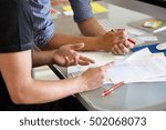 Two men with paperwork, close up