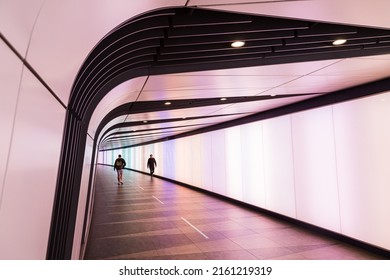 Two Men Pass One Another In  Kings Cross Light Tunnel Which Links The International Train Station And The London Underground Pictured In May 2022.