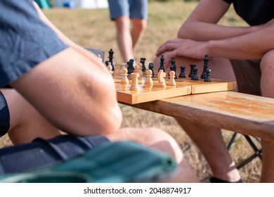 Two Men Playing Chess Outside.