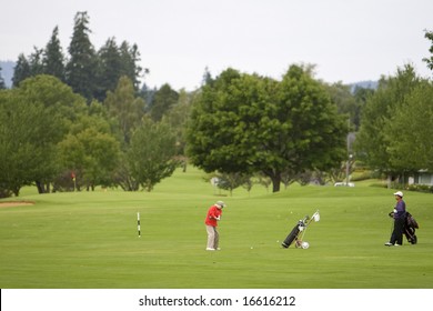 Two Men Playing Golf At A Golf Course - Horizontal