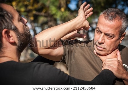 Two men quarrel and fight. Kapap instructors demonstrates street fighting techniques. Training demonstration