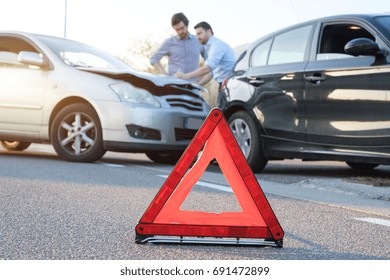Two men reporting a car crash for the insurance claim - Shutterstock ID 691472899