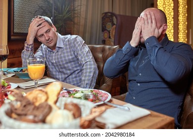 Two Men In A Restaurant Arguing During Lunch