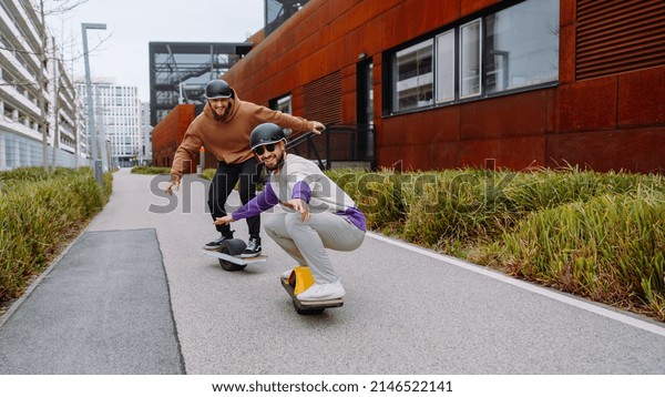 Two Men ride electric skateboards. Electric\
skateboard crew. the future live\
style