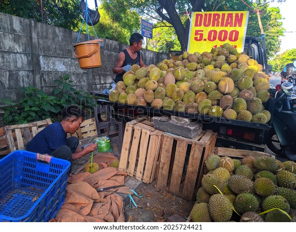 Two men are selling durian or Durio zibethinus to
their customers and they are using their car.  Makassar, 14 August
2021.
