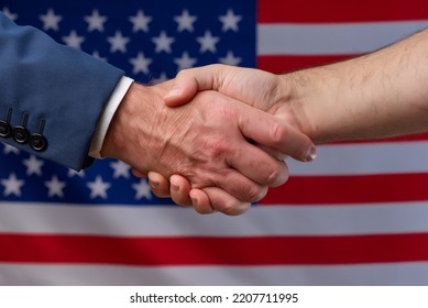 Two men shaking hands with the United States flag in the background. Cooperation and political protection of citizens in America. Alliance with the USA