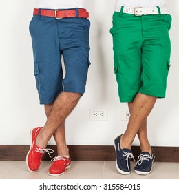 Two Men In Shorts Green And Blue Colors On White Background