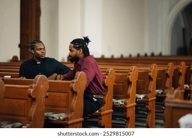 Two men are sitting in a church pew, deep in conversation about religion. The wooden pews and stained glass windows create a peaceful atmosphere - Powered by Shutterstock