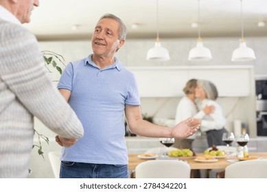 Two men smiled and greeted each other with a firm handshake before taking their seats at the beautifully set dinner table