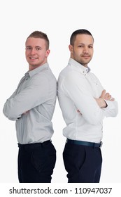 Two Men Standing Back To Back Against A White Background