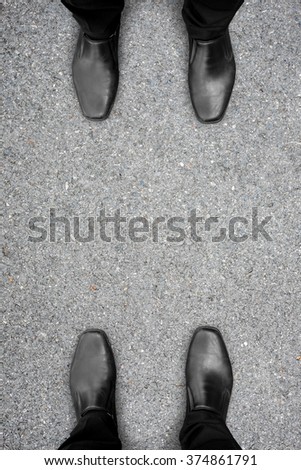 Two men standing in front of each other like enemy, competent, rival or friends