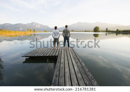 Similar – Man standing barefoot on a wooden walkway