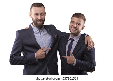 Two Men In Suits Hugging And Point The Finger At Each Other