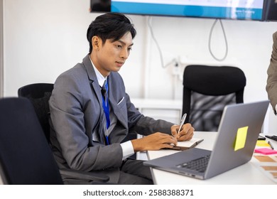 Two men in suits are looking at a computer screen with graphs and charts. They are discussing the data and making decisions based on the information presented. The atmosphere is serious and focused
