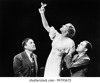 Two Men Supporting  A Woman Lifting Her Wine Glass