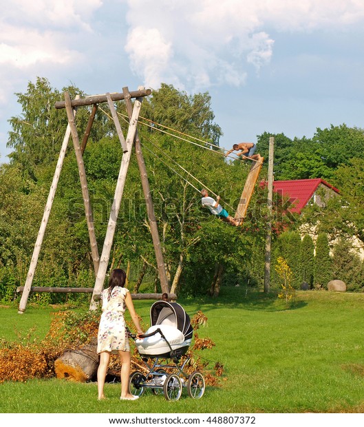 Two Men Swinging On High Homemade Stock Photo Edit Now