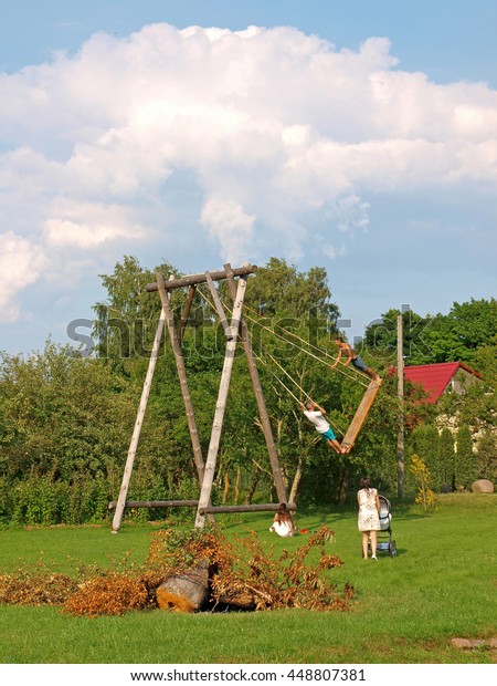 Two Men Swinging On High Homemade Stock Photo Edit Now