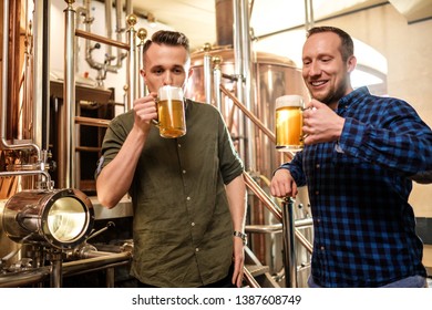 Two men tasting fresh beer in a brewery - Powered by Shutterstock