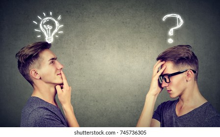 Two men thinking one has a question another solution with light bulb above head isolated on gray background. - Shutterstock ID 745736305