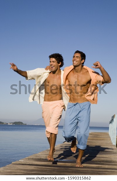 Two Men Walking Arm Arm On Stock Photo Edit Now