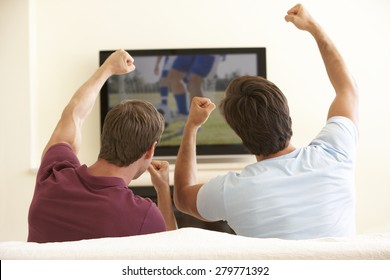 Two Men Watching Widescreen TV At Home