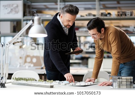 Two men working in design and engineering architecture office.