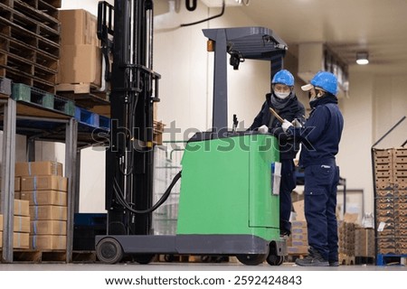 Two men working in a warehouse