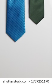 Two Men's Ties In Different Colors And Sizes. For Father And Son. Love And Togetherness Objects. On A White Background