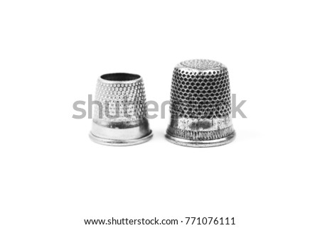 Two metal silver sewing thimbles on a white background. Sewing accessories and tools