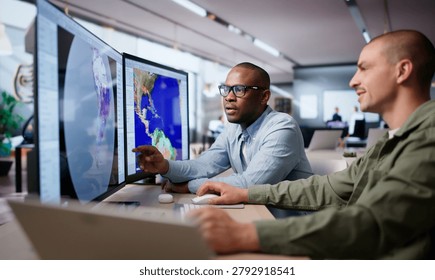 Two Meteorologists Analyze Climate Data On Computers Predicting Hurricane Impact.