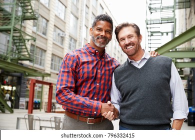 Two Middle Aged Men Shaking Hands Outside Their Workplace