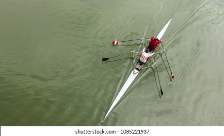 Two middle-aged man in a sports boat, rowing on the river - Powered by Shutterstock