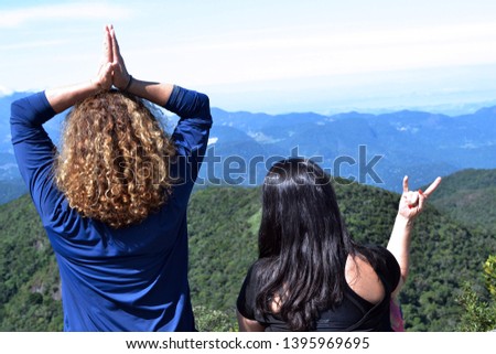 two midle age woman looking at the view os the montais. Concept of adventure, friendship, peace, partnership