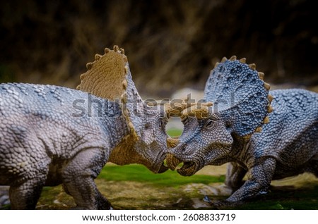 Two mighty Triceratops clash in a dramatic standoff, symbolizing the raw power and instinct-driven rituals of prehistoric life. With their massive frills and three horns.