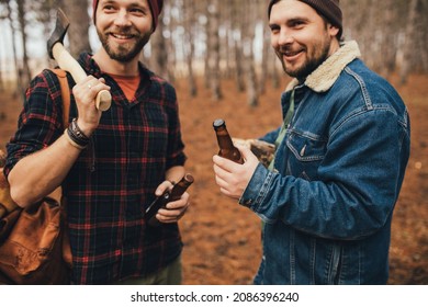 Two Millennial Man Hiking And Drinking Beer In A Pine Forest, Laughing And Having Fun.